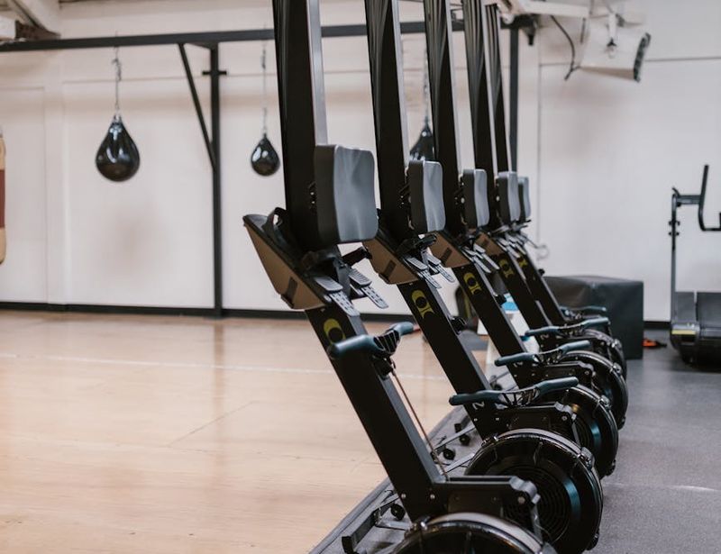 Spacious gym with modern equipment and natural wooden floor accents