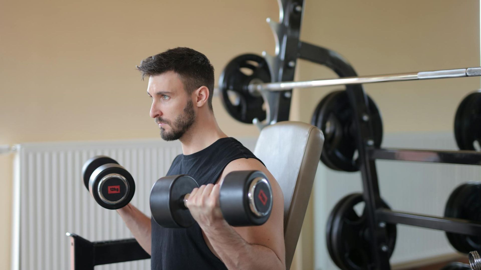 Strong man focused on lifting weight in a professional gym environment